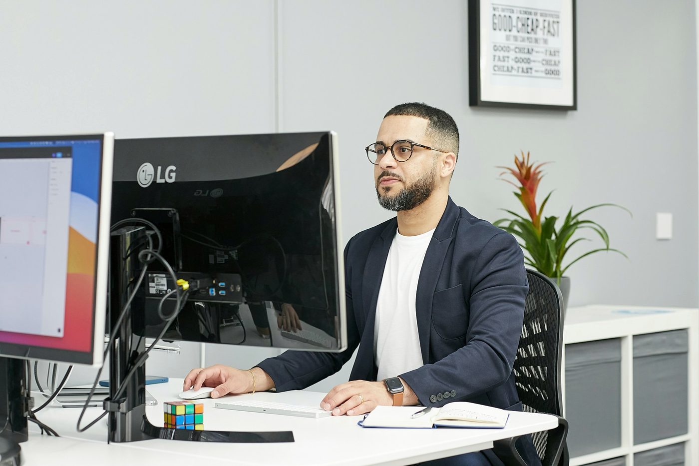 An analyst at a desk with two monitors.