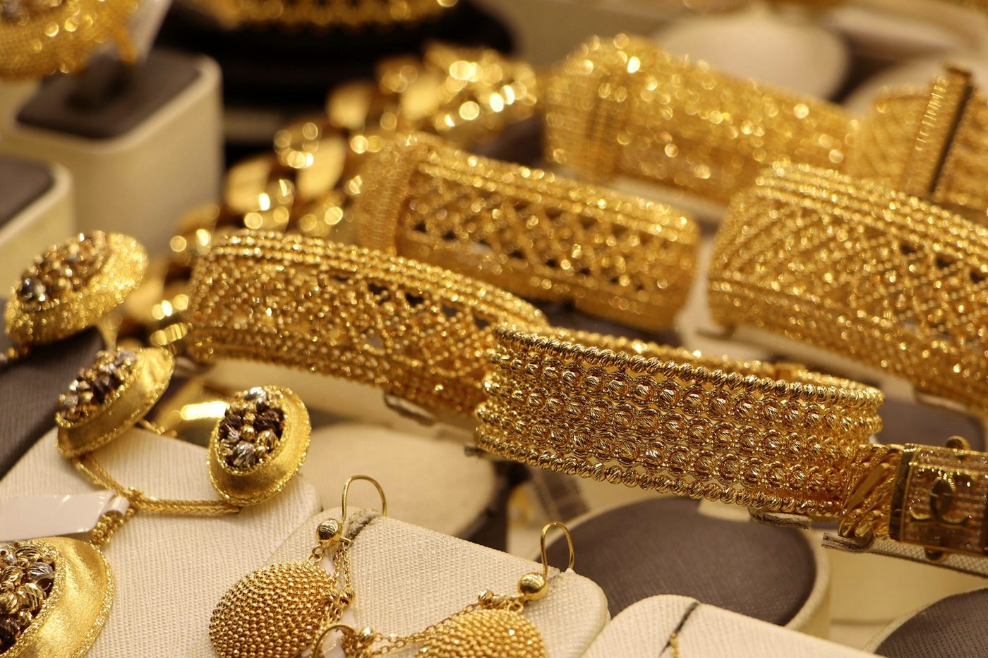 Gold bracelets and jewellery on display in a shop.